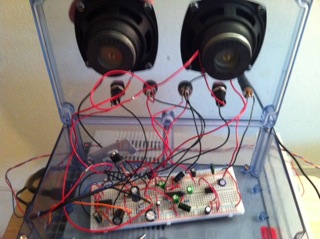 The signal passes through a series of amplifiers and filters to produce a heartbeat sound through headphones or speakers  